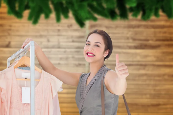 Imagen compuesta de una mujer sonriente dando pulgares hacia arriba —  Fotos de Stock