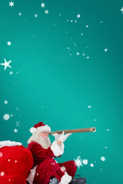 Santa claus looking through telescope — Stock Photo, Image