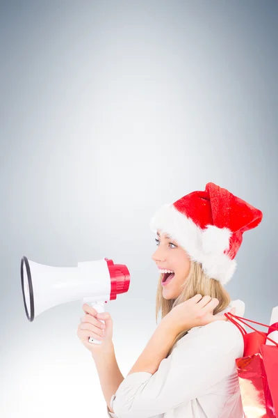 Blonde holding megaphone and bags — Stock Photo, Image