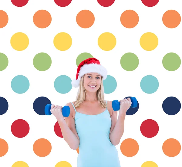 Festive blonde holding dumbbells — Stock Photo, Image