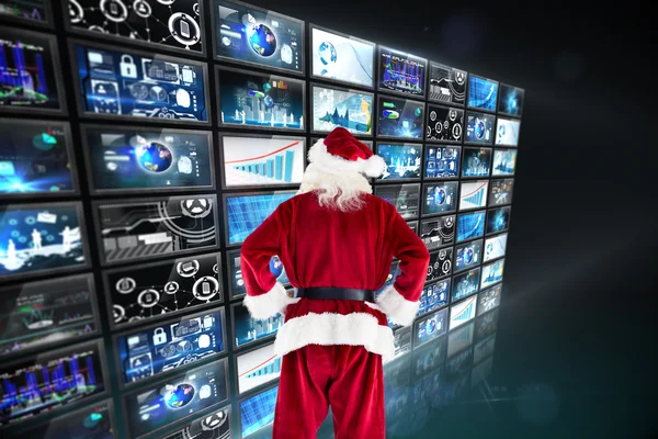 Santa Claus against screen collage — Stock Photo, Image