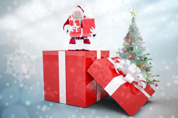 Santa standing in large gift — Stock Photo, Image