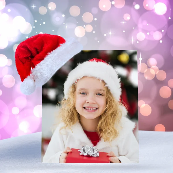 Festive little girl holding a gift — Stock Photo, Image