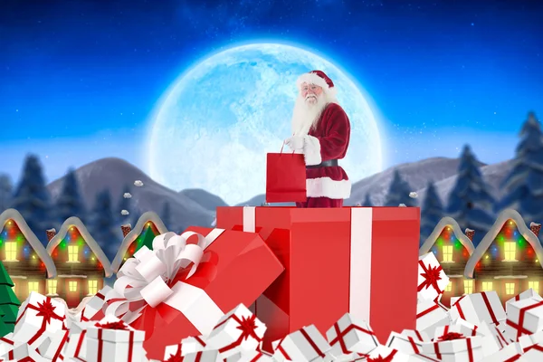 Santa standing in large gift — Stock Photo, Image