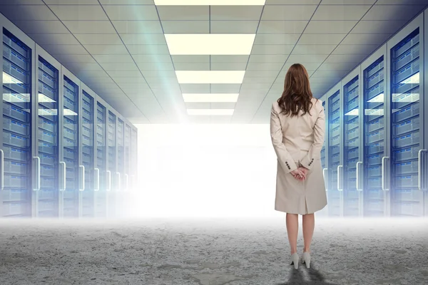 Businesswoman against server hallway — Stock Photo, Image