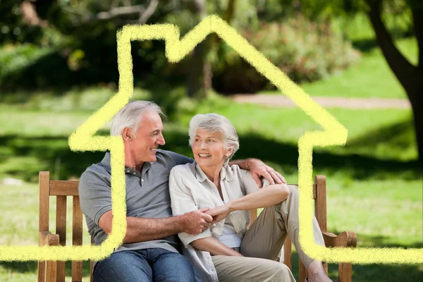 Senior couple sitting on a bench — Stock Photo, Image