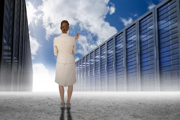 Thinking businesswoman against server hallway — Stock Photo, Image