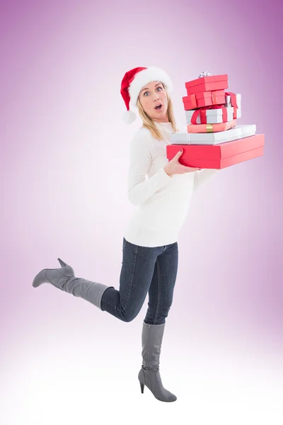 Festive blonde holding pile of gifts — Stock Photo, Image