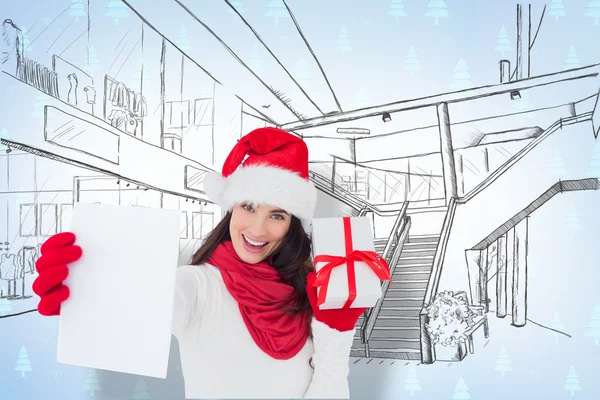 Festive brunette holding gift — Stock Photo, Image