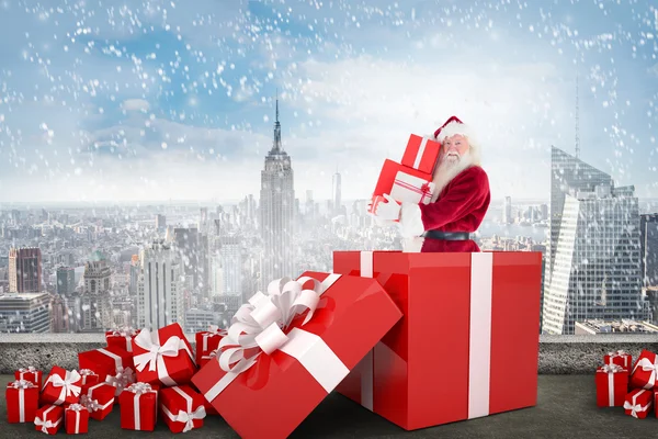 Santa standing in large gift — Stock Photo, Image