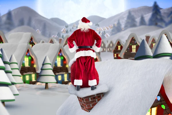 Santa på stuga tak — Stockfoto