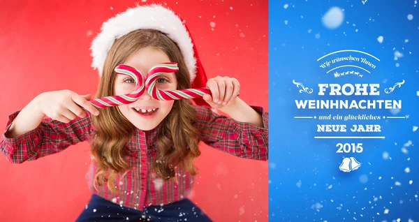 Little girl holding candy canes — Stock Photo, Image