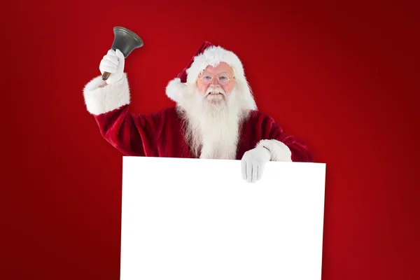 Santa houdt teken en ringen bell — Stockfoto