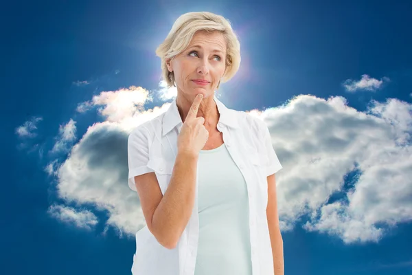 Mature woman thinking with hand on chin — Stock Photo, Image