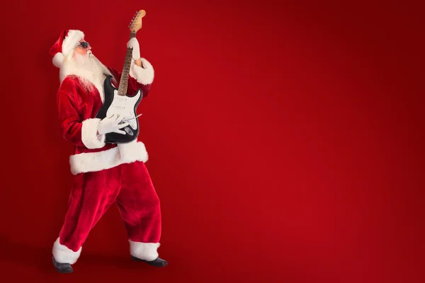 Santa tocando la guitarra eléctrica — Foto de Stock