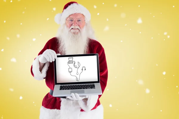 Santa Claus präsentiert einen Laptop — Stockfoto