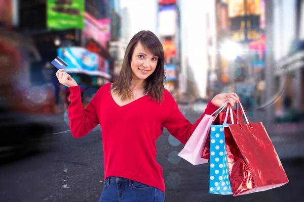 Morena sosteniendo regalos y tarjeta de crédito — Foto de Stock