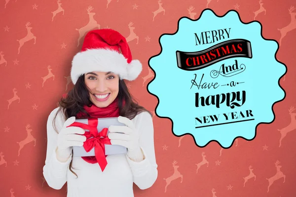 Festive brunette holding gift — Stock Photo, Image