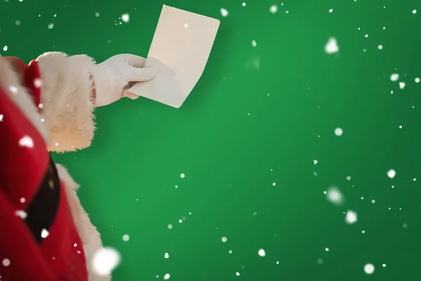 Father christmas holding paper — Stock Photo, Image