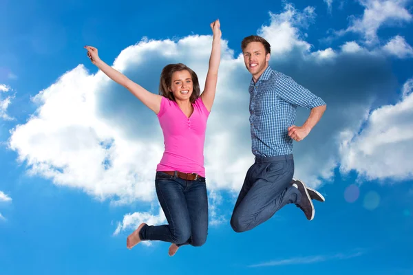 Cheerful young couple jumping Royalty Free Stock Photos