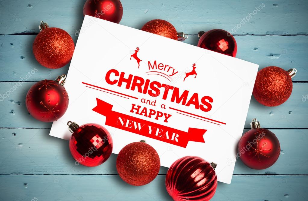 Banner and logo saying merry christmas against painted blue wooden planks