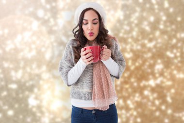 Brunette in winter clothes holding hot drink clipart