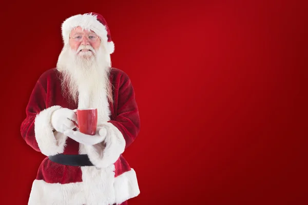 Santa sostiene copa roja — Foto de Stock