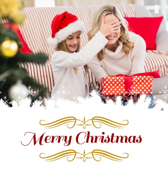 Festive mother and daughter with gift — Stock Photo, Image