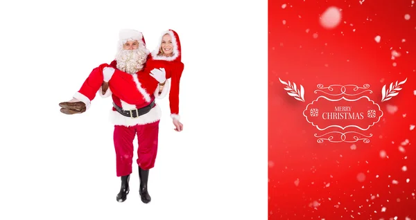 Santa and mrs claus smiling at camera — Stock Photo, Image