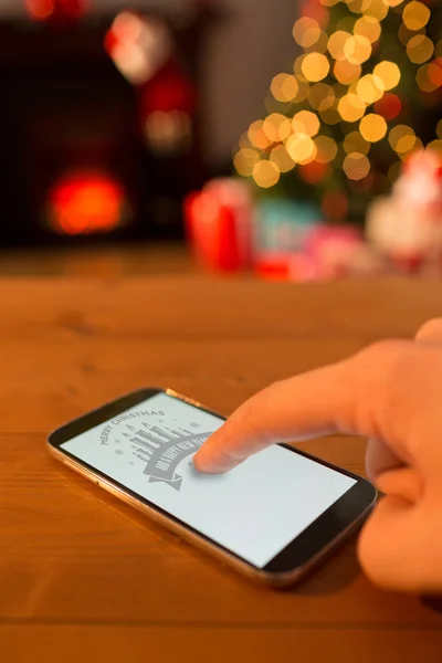 Hand using smartphone at christmas — Stock Photo, Image