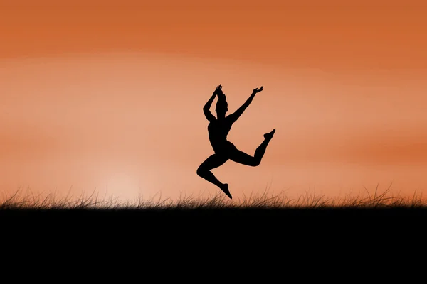 Brunette jumping against sun rising — Stock Photo, Image