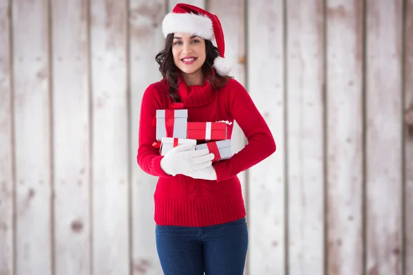 Happy brunette holding many gifts — Stock Photo, Image