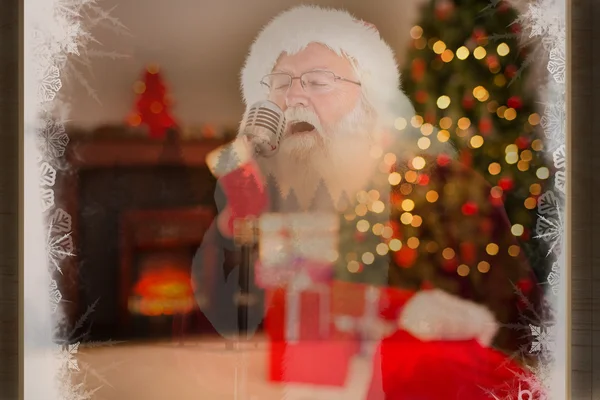 Santa claus is singing christmas songs — Stock Photo, Image