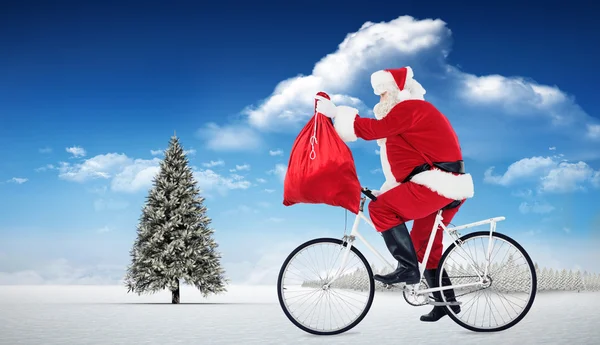 Santa cykling och hålla sin säck — Stockfoto