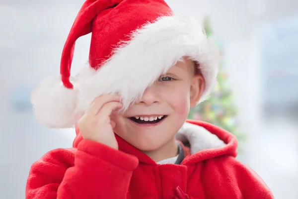 Imagem composta de menino bonito em santa hat — Fotografia de Stock