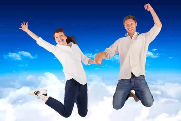 Couple jumping and holding hands — Stock Photo, Image