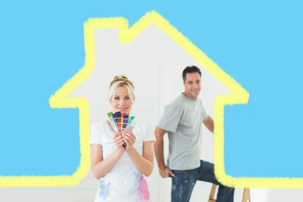 Couple with color swatches and ladder — Stock Photo, Image