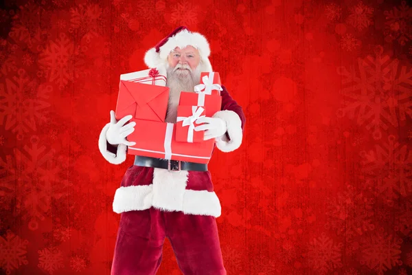 Santa draagt enkele presenteert — Stockfoto