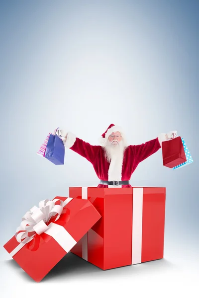Santa standing in large gift — Stock Photo, Image