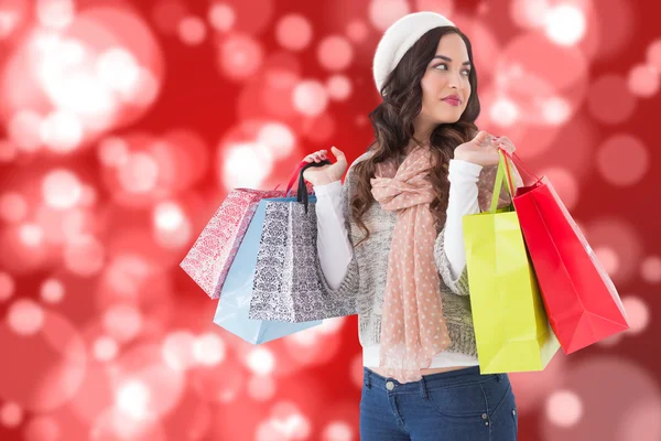 Imagen compuesta de morena reflexiva con bolsas de compras —  Fotos de Stock