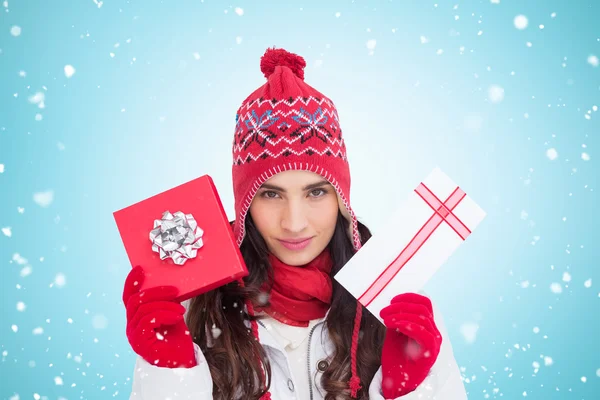 Festive brunette showing gifts — Stock Photo, Image