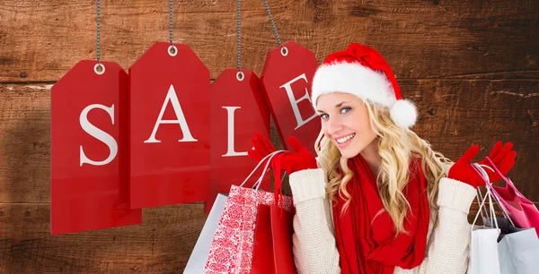 Festive blonde with shopping bags — Stock Photo, Image