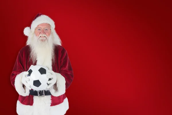 Santa holds classic football — Stock Photo, Image