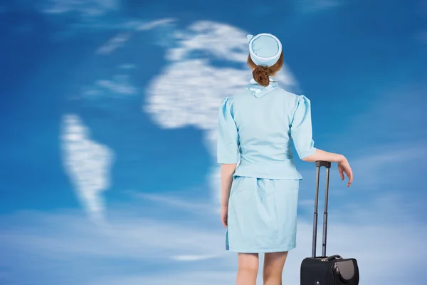 Air hostess leaning on suitcase — Stock Photo, Image