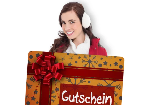 Beautiful brunette showing gift card — Stock Photo, Image