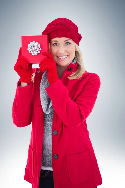 Festive blonde holding red gift — Stock Photo, Image