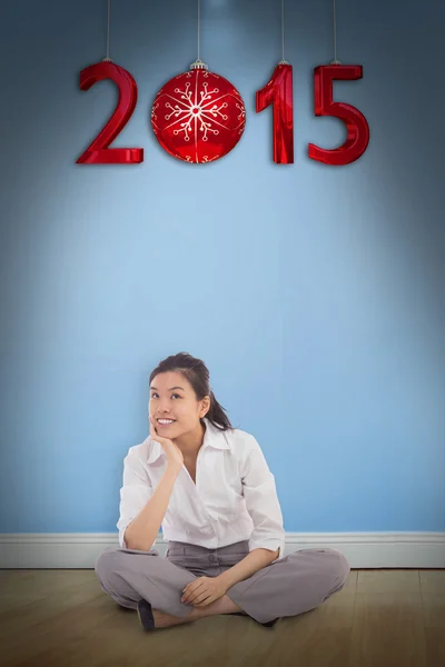 Businesswoman sitting cross legged thinking — Stock Photo, Image