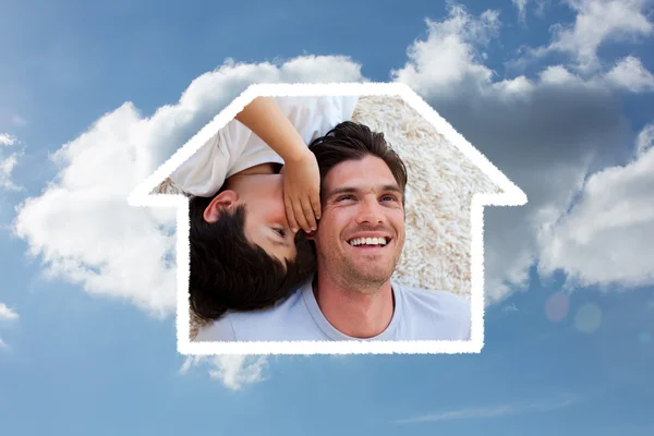 Close up of a little boy and his father lying — Stock Photo, Image