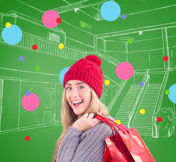 Festive blonde holding shopping bags — Stock Photo, Image