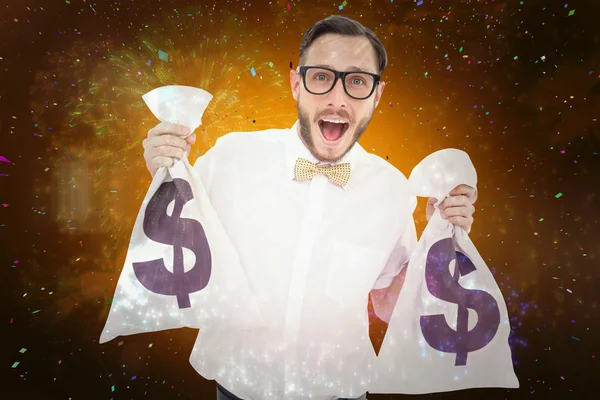 Geeky businessman holding money bags — Stock Photo, Image